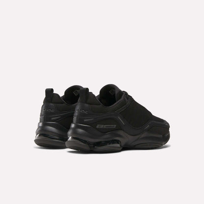The Reebok DMX Series 3000 Shoes in black feature chunky soles with DMX moving air technology for exceptional comfort, shown from the back and side on a plain light background.