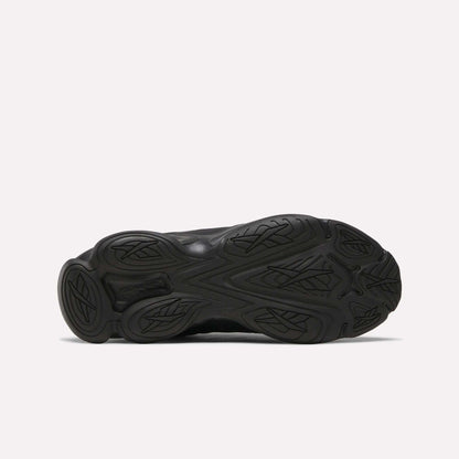 The image shows the black rubber outsole of the Reebok DMX Series 3000 Shoes, featuring DMX moving air technology and a wavy, textured tread pattern with decorative grooves visible on the sole.
