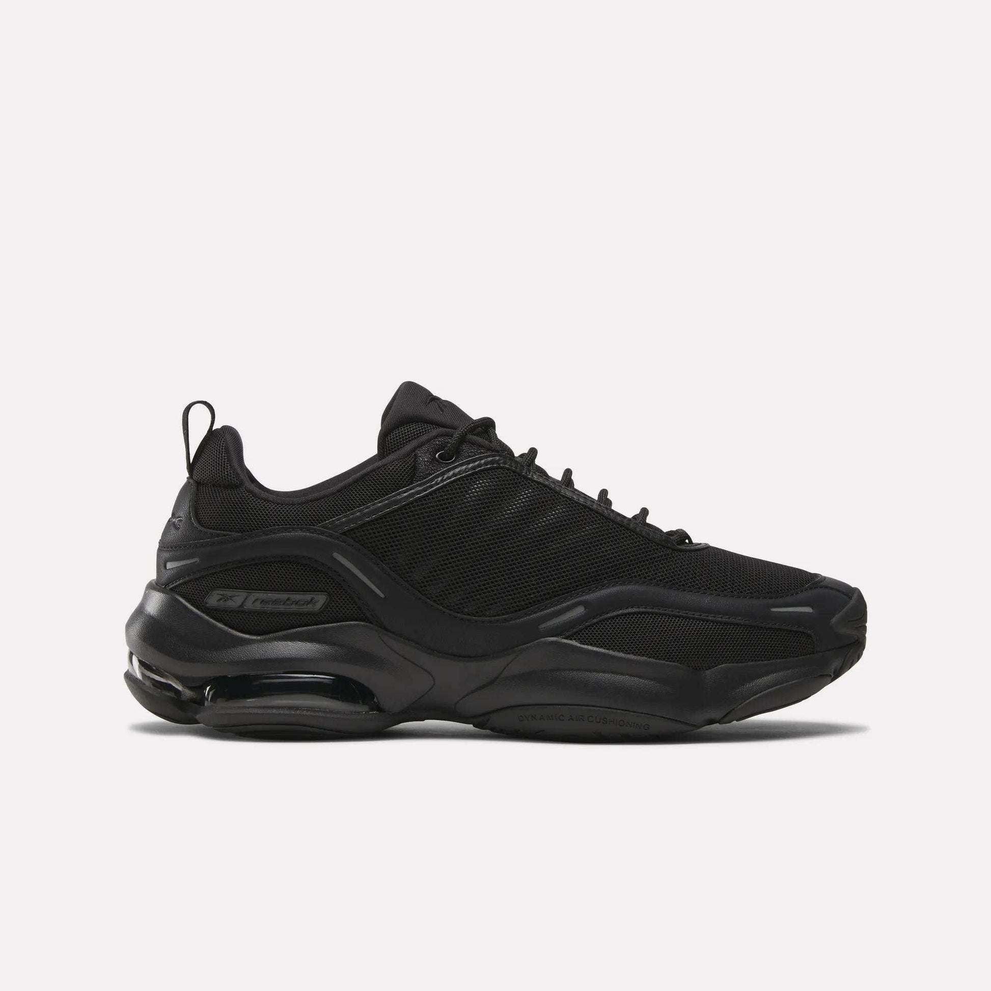 The Reebok DMX Series 3000 Shoes in black have a chunky sole, mesh and synthetic overlays, lace-up closure, and DMX moving air tech for comfort, shown in side view against a plain white background.