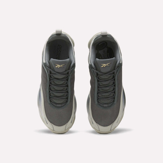 Top view of Reebok DMX Series 3000 Shoes in gray, with white soles, mesh uppers, and a gold logo on the tongues. Features DMX moving air technology for comfort. Displayed on a plain white background.