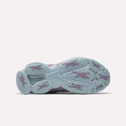 The image displays the light blue outsole of Reebok Women's DMX Series 3000 Training Shoes with wavy grooves, purple accents, and DMX 3 Technology for comfort, viewed from the bottom against a plain white background.