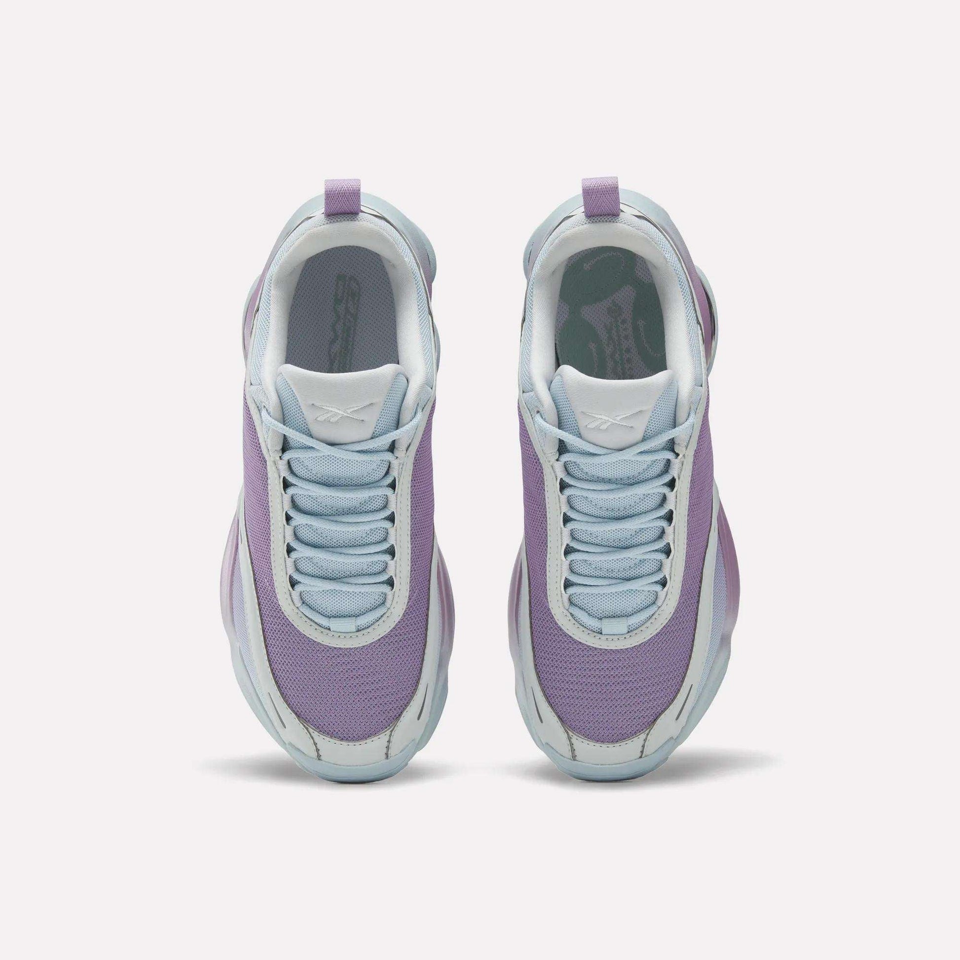 Top view of Reebok Women's DMX Series 3000 Training Shoes with light purple mesh uppers, white soles, and pale blue laces, featuring DMX 3 Technology for cushioned comfort—all side by side on a plain white background.