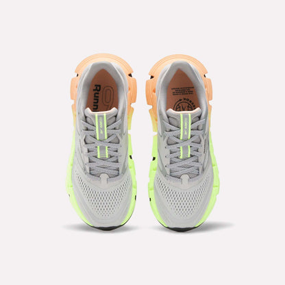 The Reebok Women's FloatZig 2 Running Shoes feature gray mesh uppers, neon green and peach accents, laces, and cushioned Superfloat+ soles, shown from above.