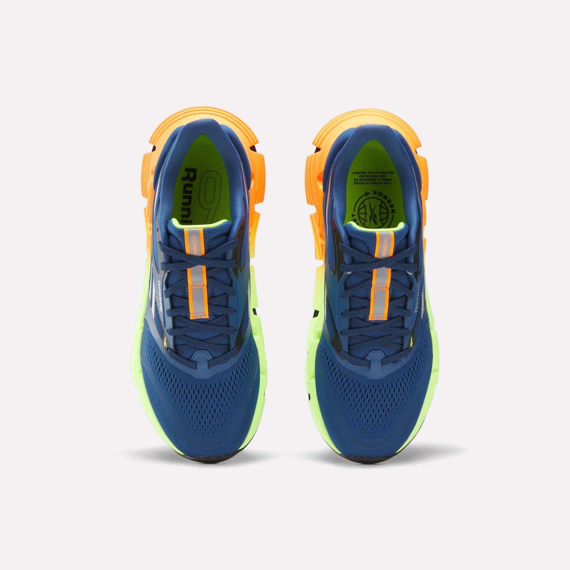 A pair of Reebok Men's FloatZig 2 Running Shoes in blue with orange accents and yellow-green soles, featuring Superfloat+ cushioning, viewed from above on a white background.