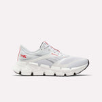 Introducing the Men's FloatZig 2 Running Shoes by Reebok—a white running shoe featuring gray and red accents, a breathable mesh upper, and a chunky white sole with black detailing enhanced by Superfloat+ cushioning. Pictured from the side on a plain background, these shoes are ideal for men seeking top-tier comfort and performance in their running footwear.