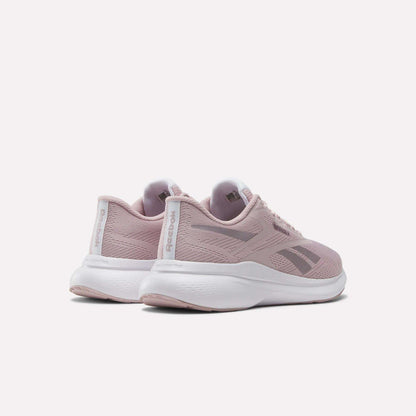 The Reebok Women's Energen Run 4 Running Shoes in light pink feature a breathable mesh upper and white soles, shown from back and side angles against a plain white background.