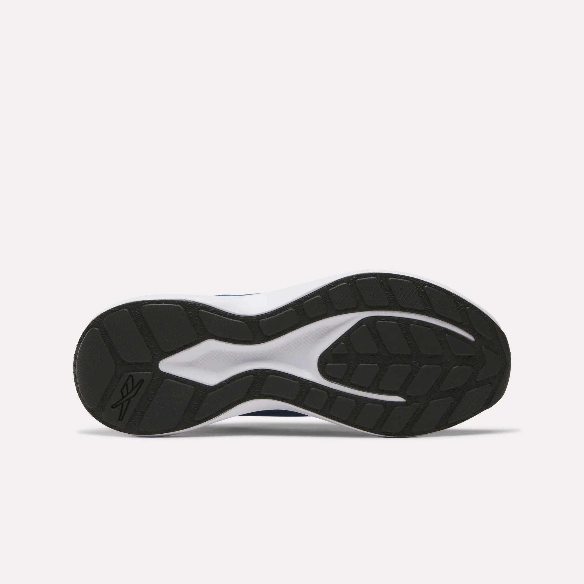 The image shows the black rubber outsole of Reebok Men's Energen Run 4 Running Shoes, featuring a patterned tread and white FuelFoam midsole accents. The lightweight shoe is displayed sole-up against a plain white background.