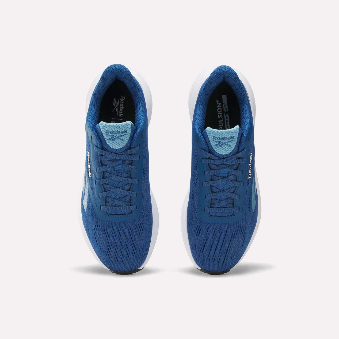 Top view of Reebok Men's Energen Run 4 Running Shoes with breathable mesh uppers, white soles, and visible Reebok logos on sides and tongues, shown side by side on a plain light background.