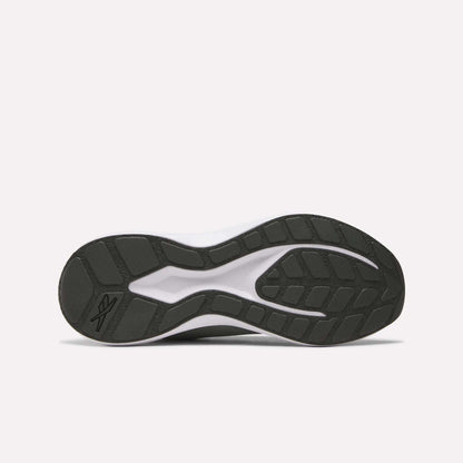 The image displays the black rubber outsole of the Reebok Men's Energen Run 4 Running Shoes, featuring a grip tread pattern and visible logo near the heel. Designed for lightweight comfort, it complements a mesh upper and FuelFoam midsole. Background is plain white.