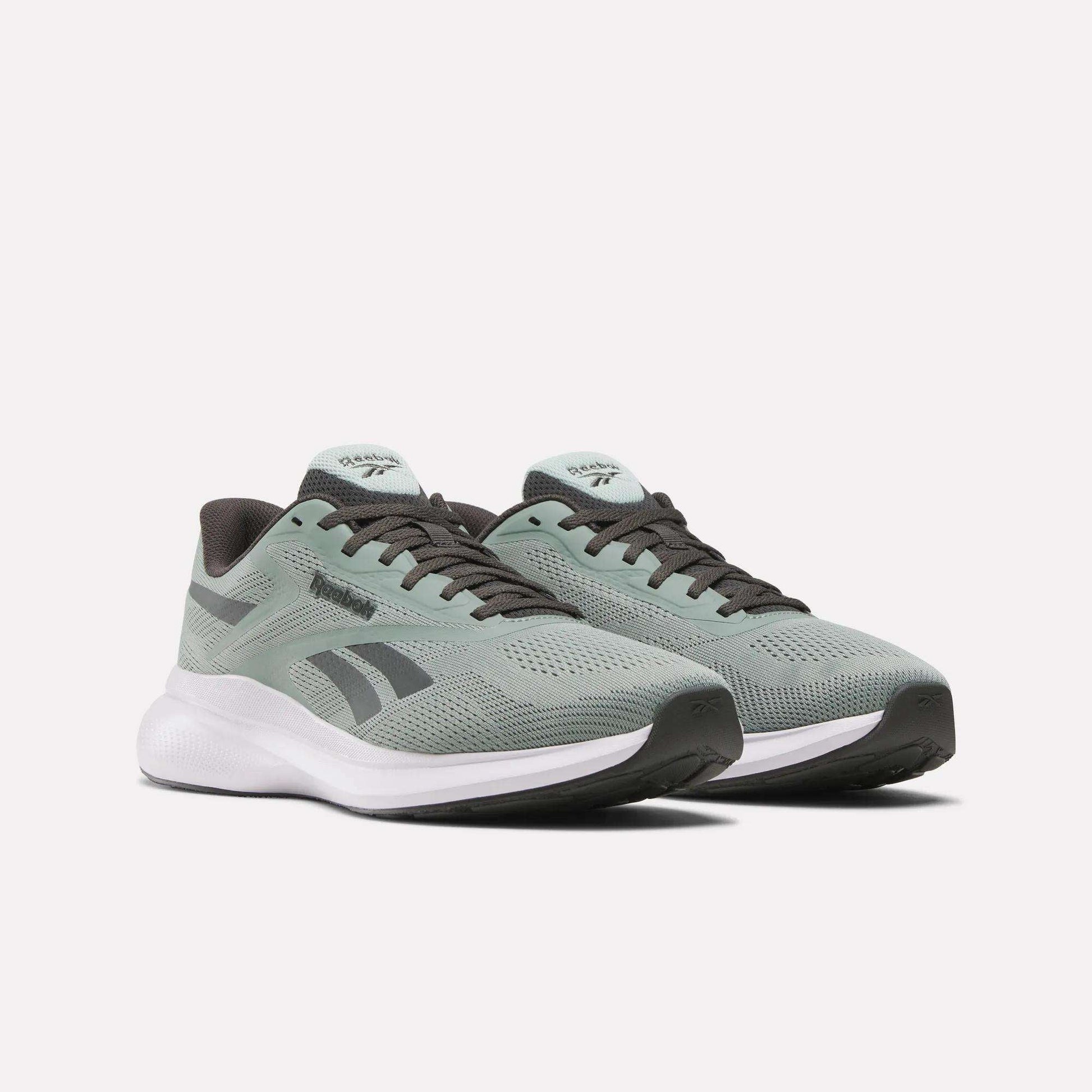Men's Energen Run 4 Running Shoes by Reebok, in light green with black and white accents, feature a breathable mesh upper and cushioned white FuelFoam midsole, shown on a plain white background.
