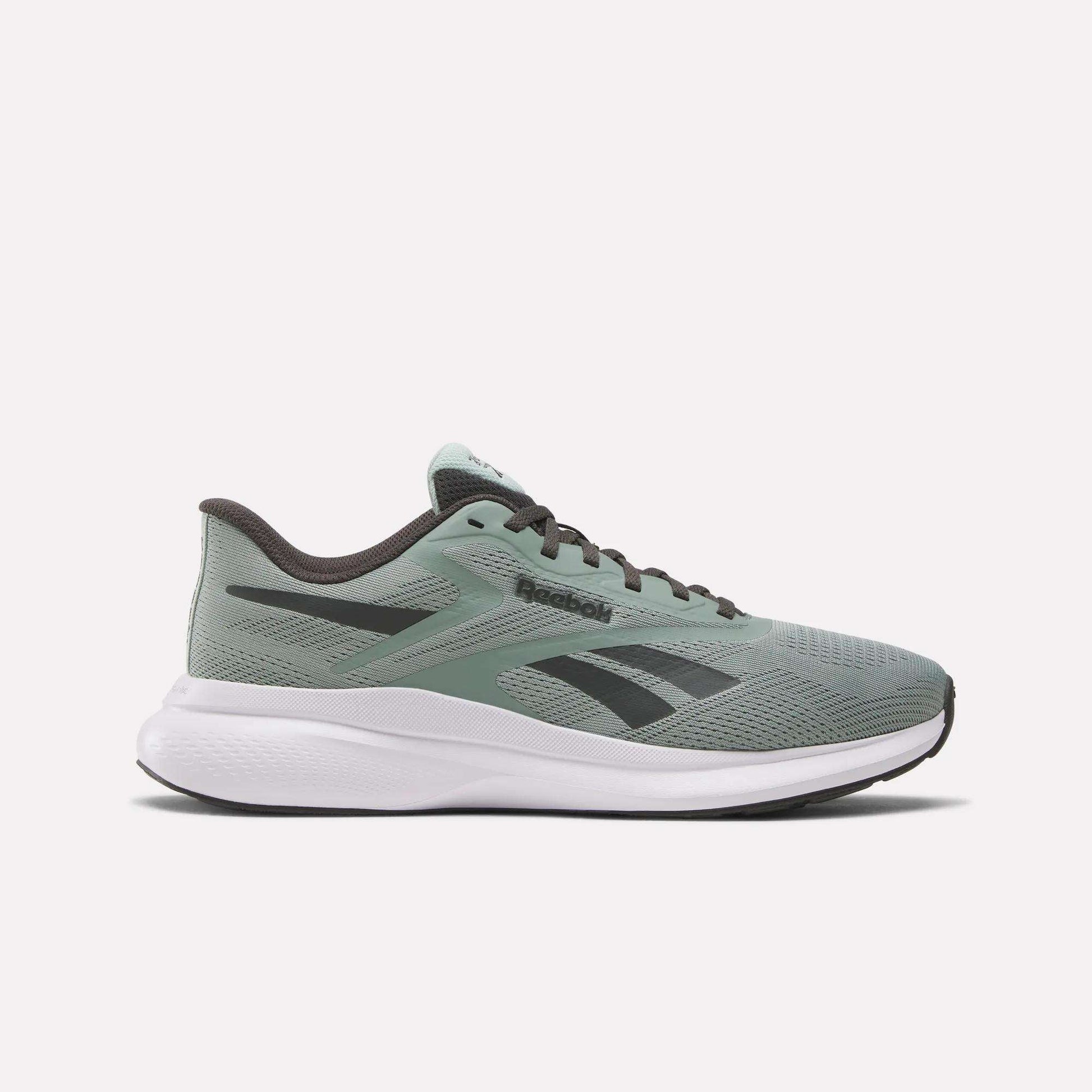 The Reebok Men's Energen Run 4 Running Shoes in sage green display a black logo, black laces, white cushioned sole, and a breathable mesh upper, shown in side profile on a plain white background.