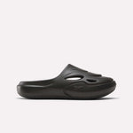 The Reebok DMX Recovery Mules are black slip-on shoes made from molded EVA, with cutout vents on the upper, a closed toe, and a chunky sole. Shown in side profile against a plain white background.
