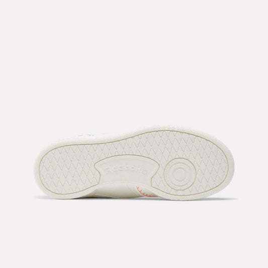 The image shows the sole of the Reebok x DORA Club C Shoes for little kids, laid flat to display the tread pattern and an embossed Reebok logo at the center.