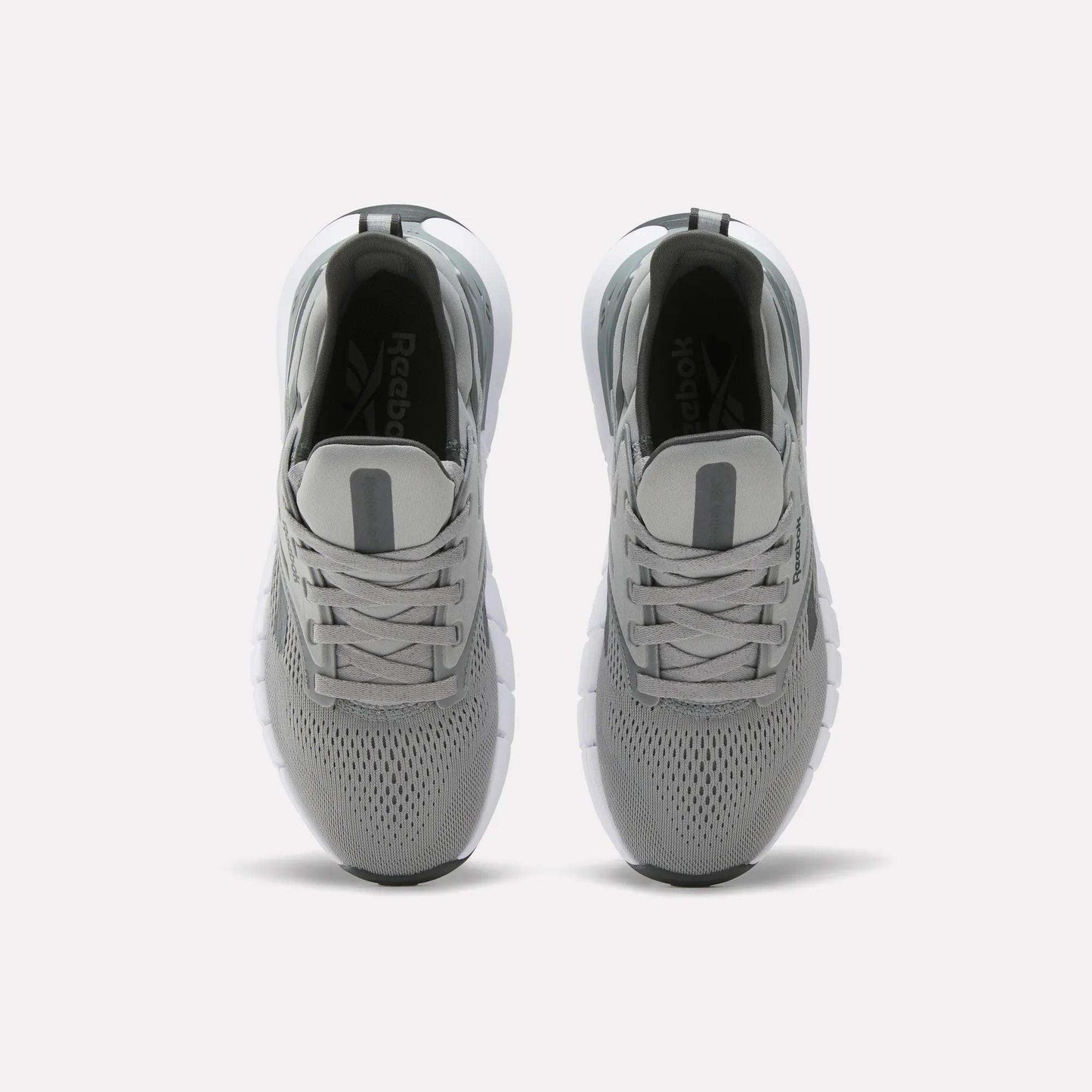 A pair of Women's Nano Gym Training Shoes by Reebok in gray, shown from above with mesh uppers, gray laces, and white soles on a plain white background.