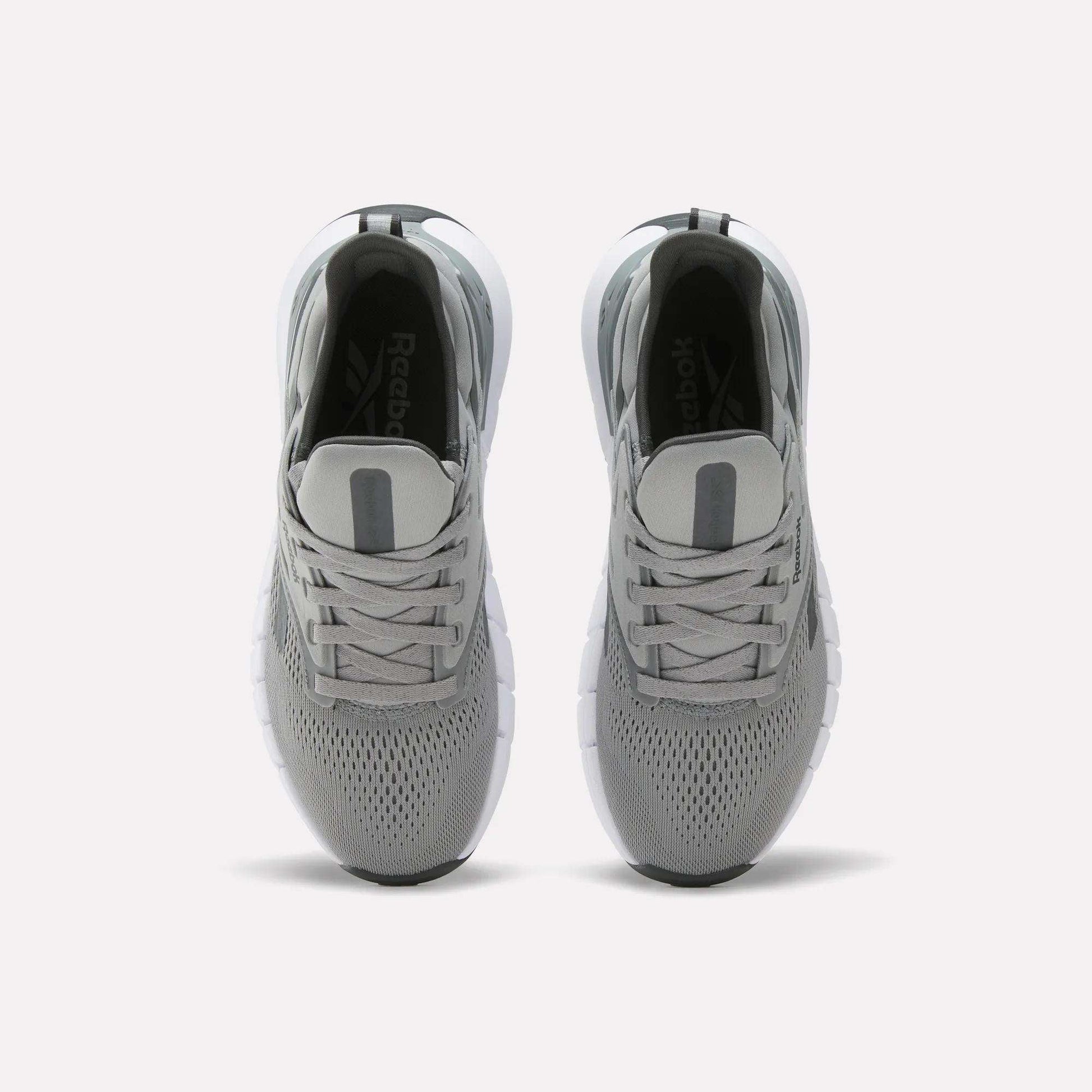 A pair of Women's Nano Gym Training Shoes by Reebok in gray, shown from above with mesh uppers, gray laces, and white soles on a plain white background.