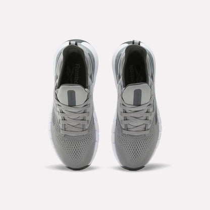 A pair of Women's Nano Gym Training Shoes by Reebok in gray, shown from above with mesh uppers, gray laces, and white soles on a plain white background.