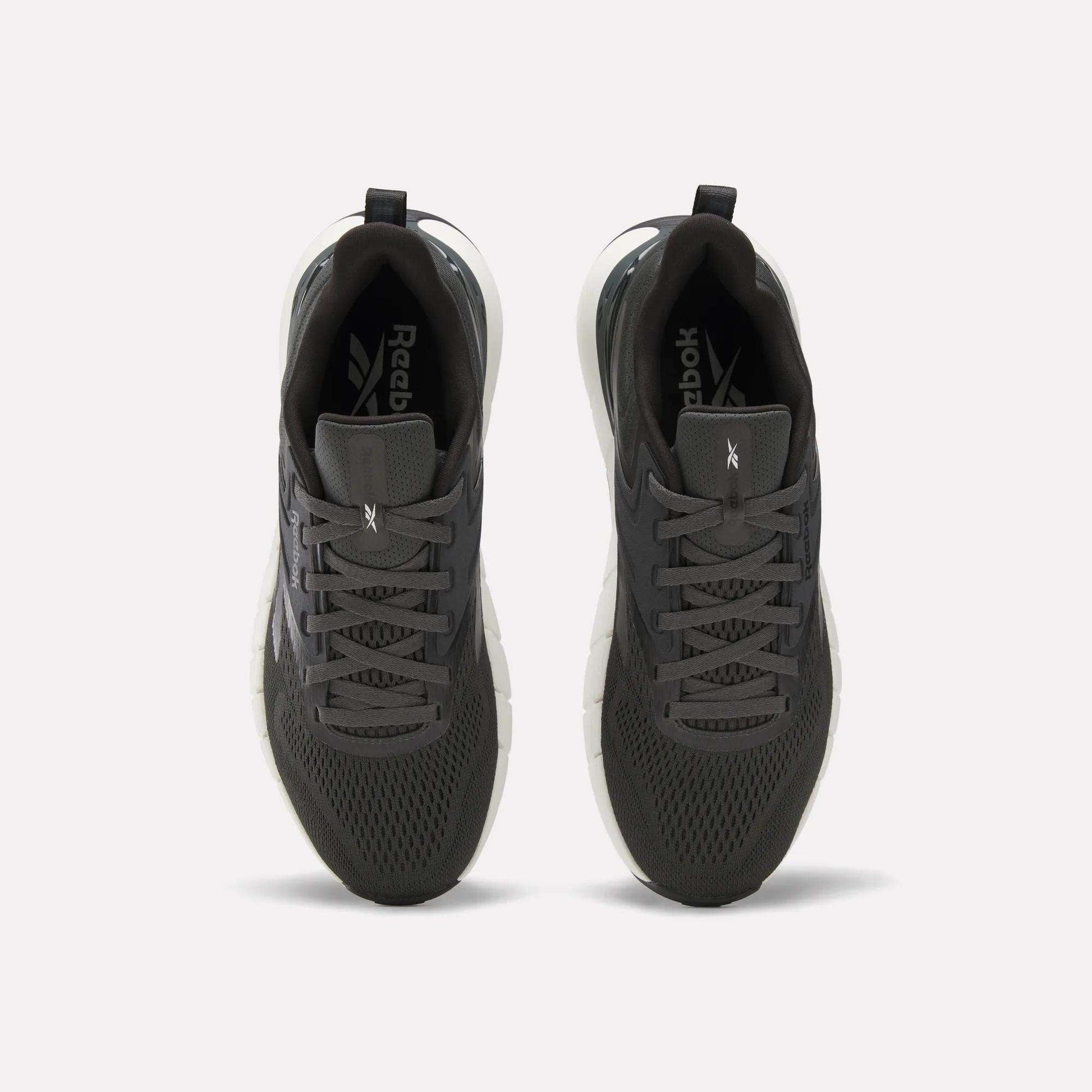 A pair of Reebok Men's Nano Gym Training Shoes in dark gray, shown from above with mesh uppers, black laces, and white soles—perfect for training, displayed on a plain white background.