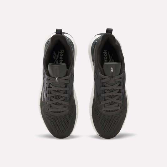 A pair of Reebok Men's Nano Gym Training Shoes in dark gray, shown from above with mesh uppers, black laces, and white soles—perfect for training, displayed on a plain white background.
