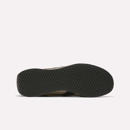 The image displays the bottom of a black sole from Reebok R400 Shoes, featuring a textured pattern of small, evenly spaced hexagons, set against a white background.