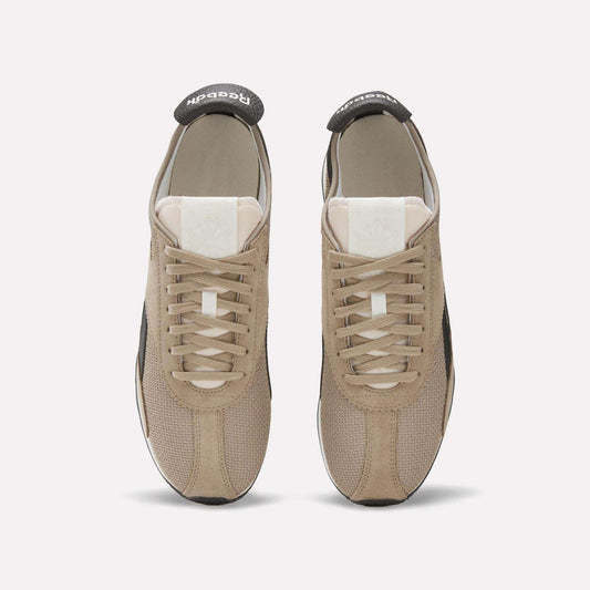 A pair of beige Reebok R400 Shoes shown from above, featuring white tongues, beige laces, and black Reebok branding on the heel tabs—stylish vintage sneakers on a plain light background.