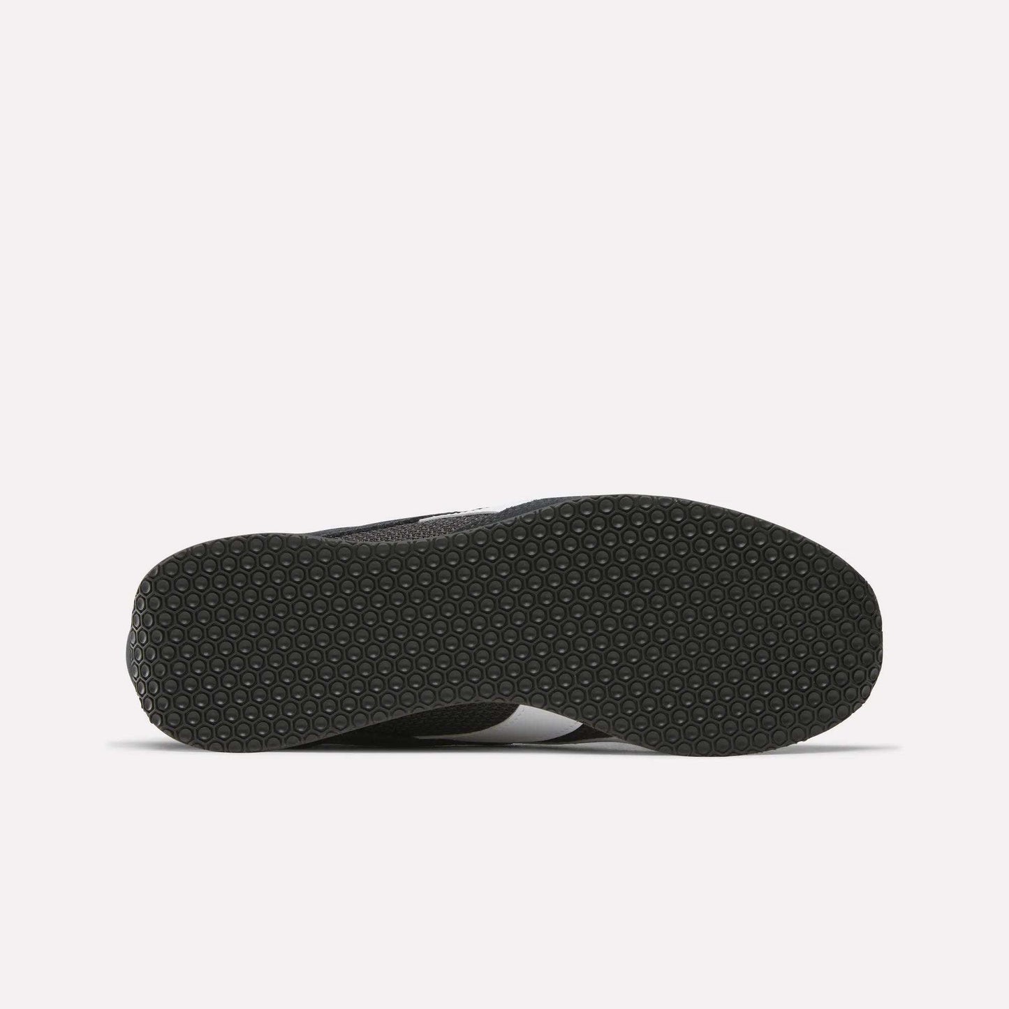 The image displays the underside of the Reebok R400 Shoes in black, featuring a textured hexagonal grip pattern. Set against a plain white background, this detail highlights the retro running design from Reebok.
