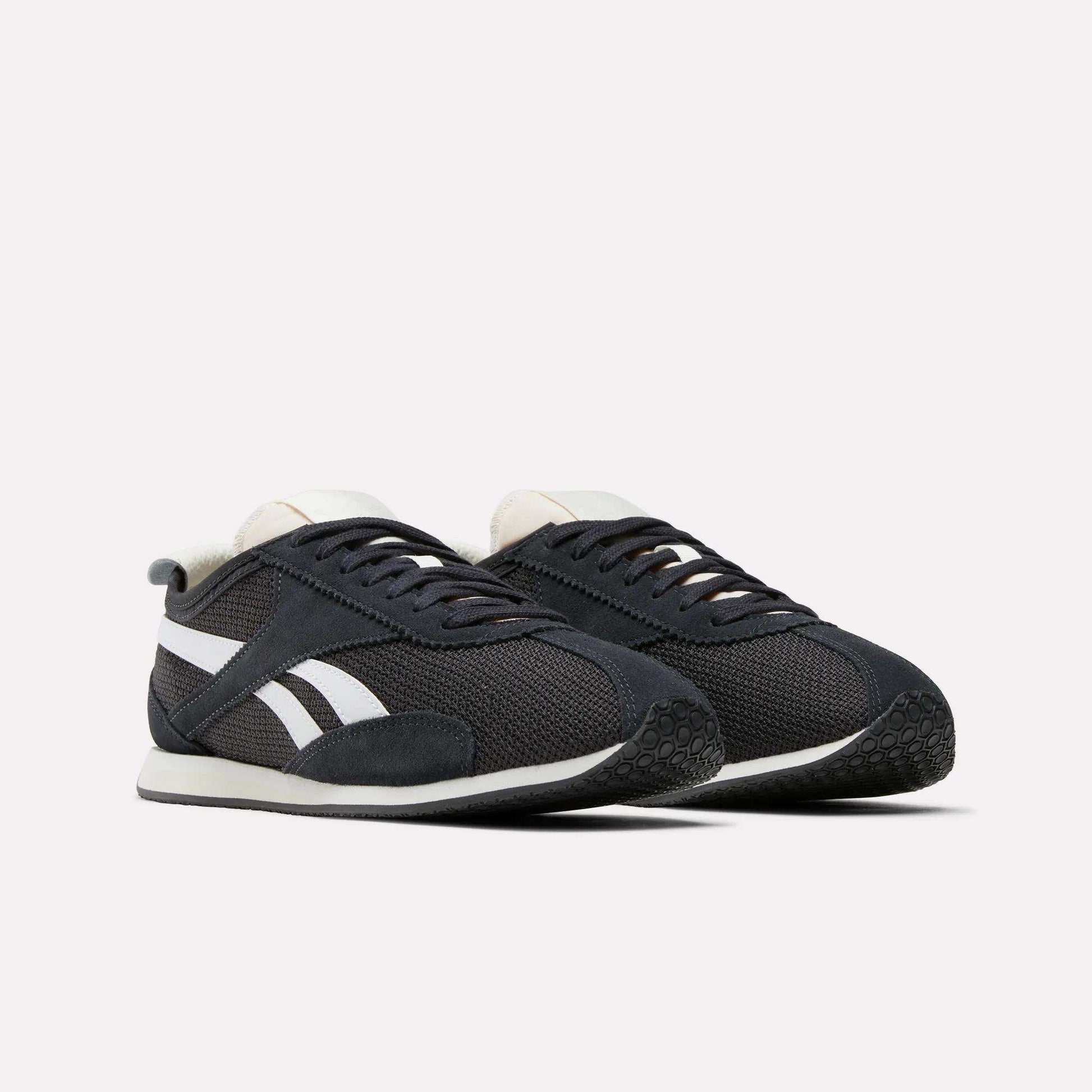 A pair of Reebok R400 Shoes in black with white soles, white side stripes, and black laces exemplifying retro running style, displayed on a plain white background.