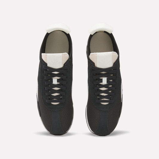 Top view of a pair of Reebok R400 Shoes, featuring black retro design with white tongues, white soles, and black laces, placed side by side on a plain white background.