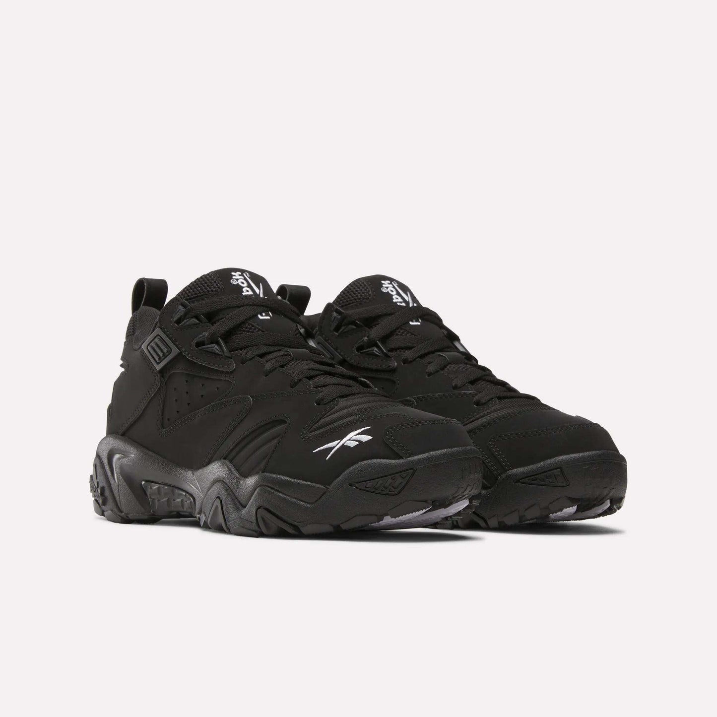 A pair of Brutus Low Shoes by Reebok, featuring chunky soles and white logos for street-ready style, showcased on a plain light background.