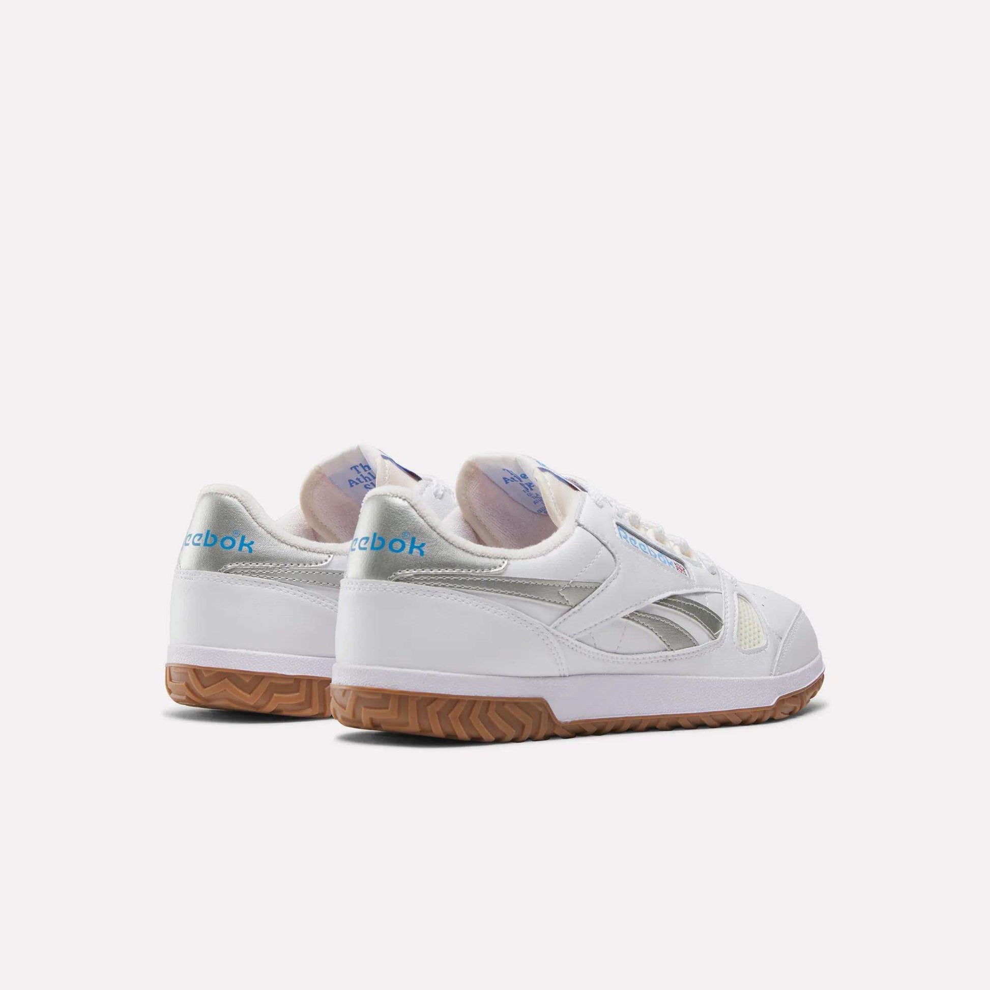 A pair of Reebok Defiance 88 Shoes in white with gum soles, metallic accents, and blue Reebok branding on the heel, shown on a plain white background.