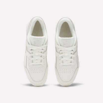 The Reebok Women's Workout Plus Shoes are shown from above on a plain white background, highlighting the laces, perforated toes, and logo details—ideal everyday workout sneakers.