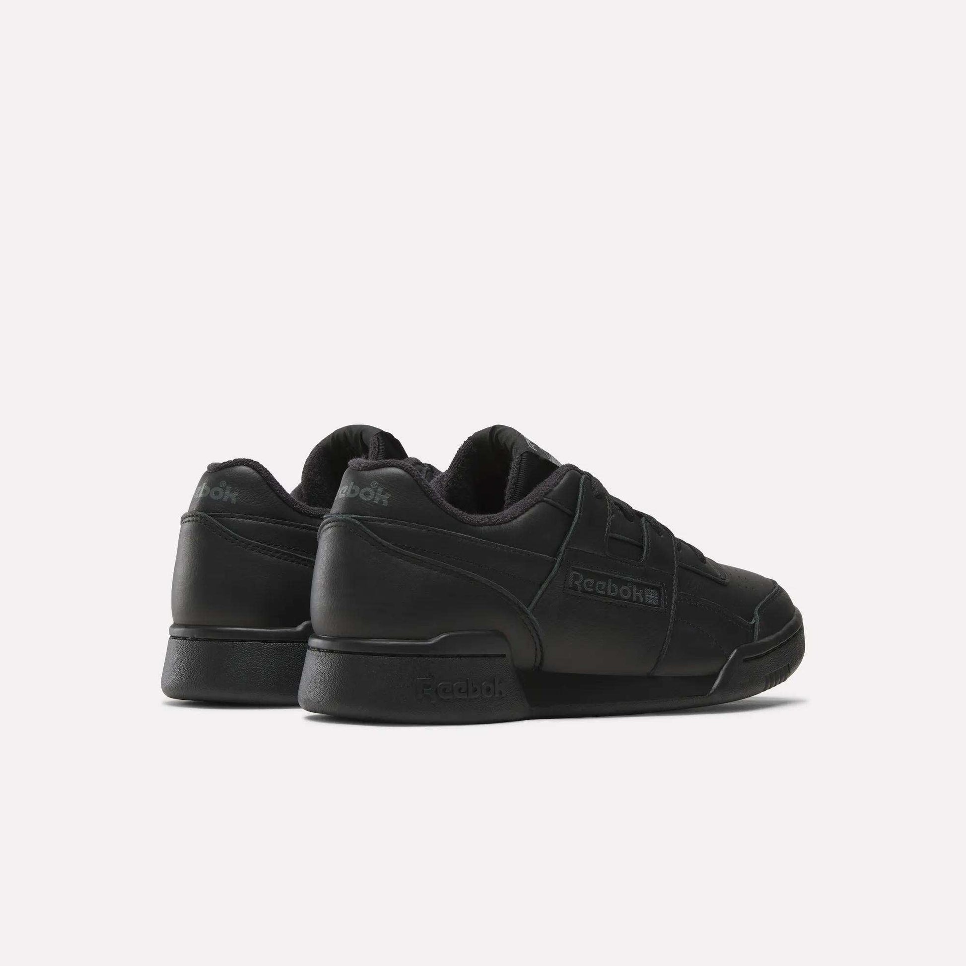 Step out in Reebok Workout Plus Shoes—classic black sneakers inspired by '80s fitness style, perfect for daily wear.