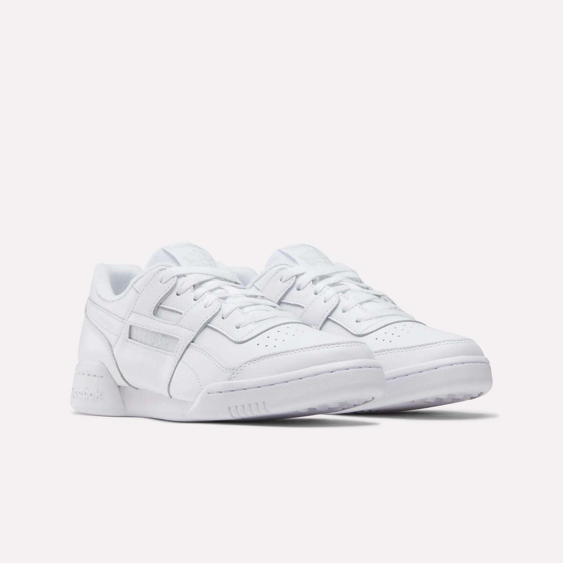 The Reebok Workout Plus Shoes are white low-top sneakers with laces, perforated toe boxes, and subtle stitching details, showcasing the iconic '80s fitness style in classic Reebok design against a plain white background.