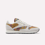 The Reebok Classic Leather 1983 Vintage Shoes feature off-white suede overlays and multicolored paisley-patterned fabric on the sides, toe, and tongue, finished with white laces and a black outsole.