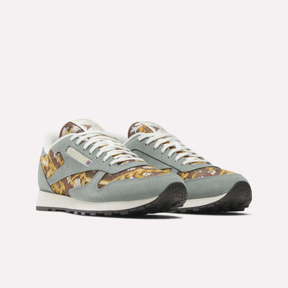 The Reebok Classic Leather 1983 Vintage Shoes feature light gray suede details, white laces, a yellow, brown, and white Persian rug-inspired pattern, black soles, and a retro design.