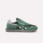 The Reebok Classic Nylon 89 Shoes feature green and black uppers with silver accents, a white midsole, and a dark gray outsole—shown in side profile on a plain white background—ideal for vintage running shoe enthusiasts.