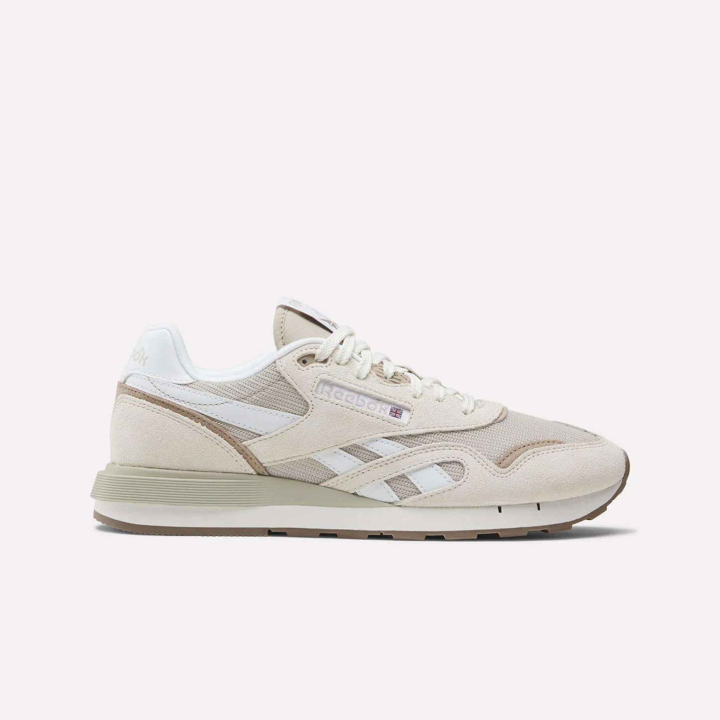 The Reebok Classic Nylon 89 Shoes feature beige and white suede and mesh panels, cushioned midsole, retro design, white laces, Reebok branding, and a low-profile rubber sole shown against a plain background.