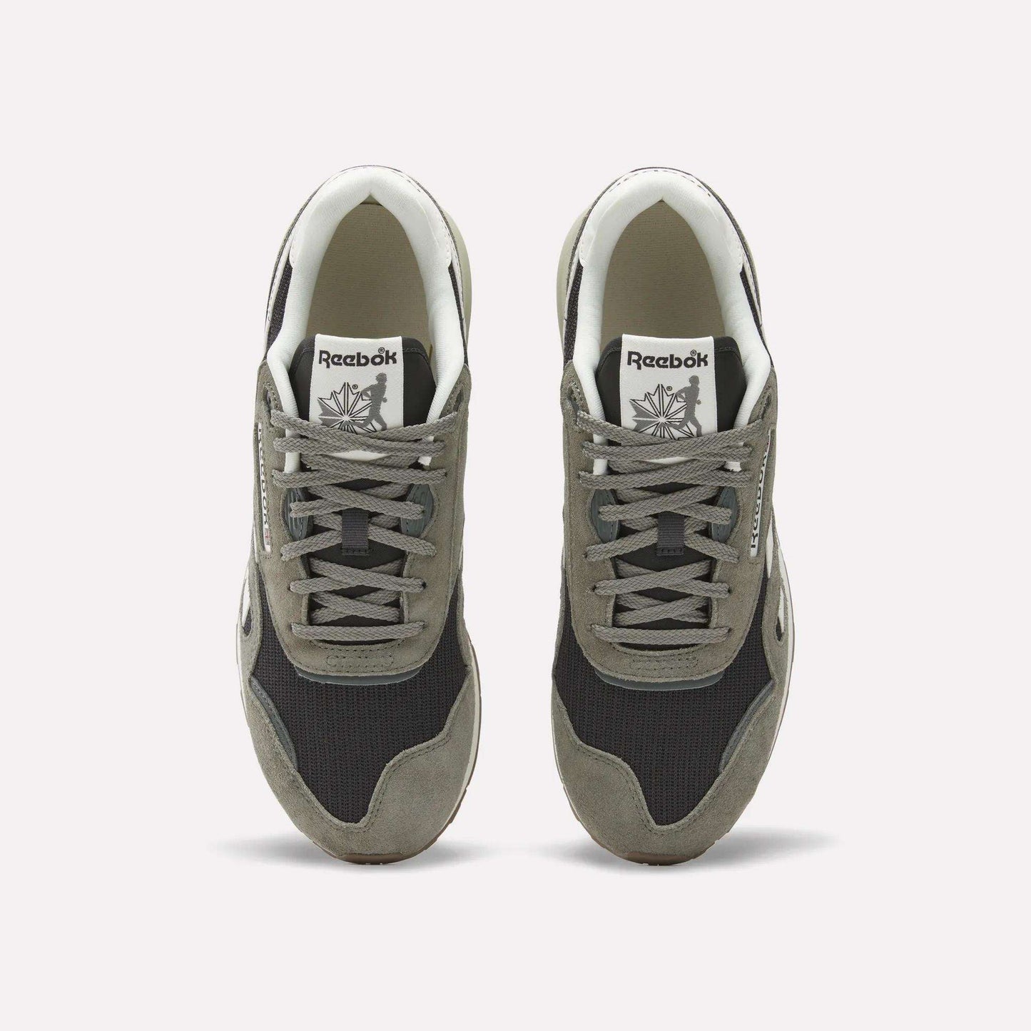 A pair of Reebok Classic Nylon 89 Shoes seen from above, with gray suede overlays, black mesh panels, white midsoles and interiors. Each heritage sneaker displays the Reebok logo on the tongue.