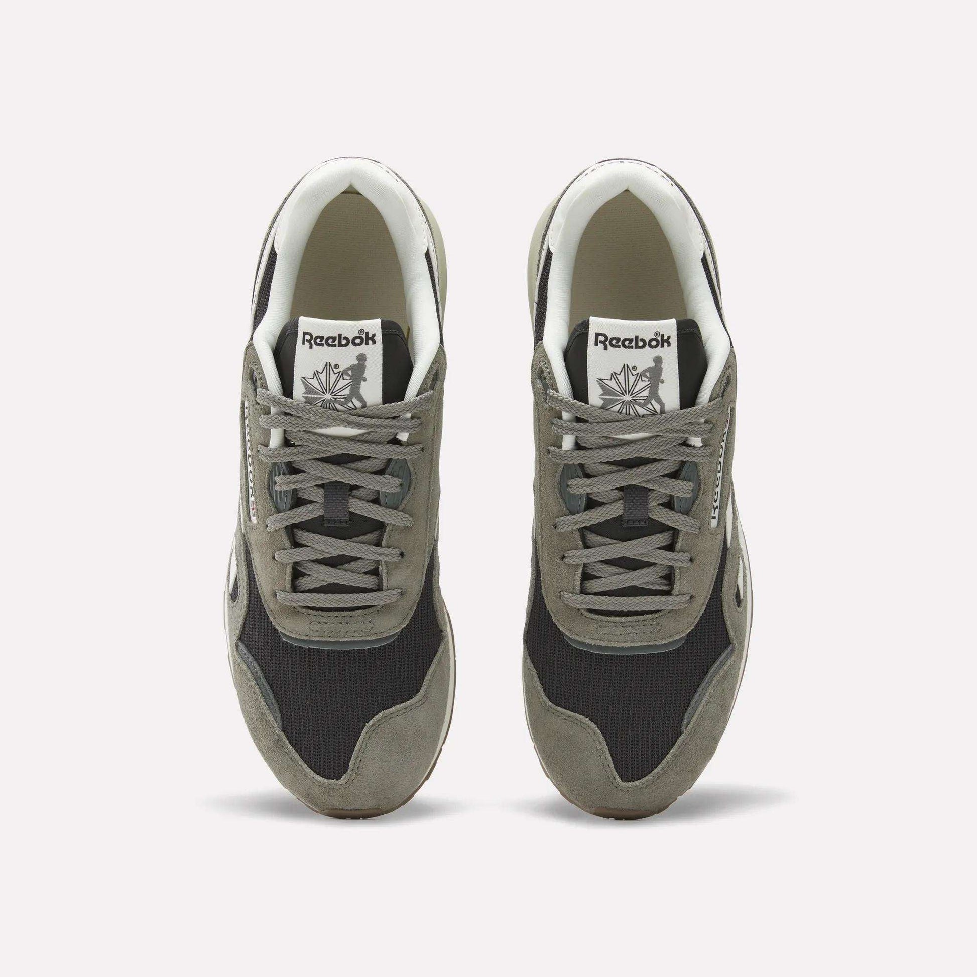 A pair of Reebok Classic Nylon 89 Shoes seen from above, with gray suede overlays, black mesh panels, white midsoles and interiors. Each heritage sneaker displays the Reebok logo on the tongue.