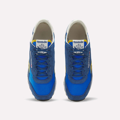 A pair of blue Reebok Aztec II Shoes with suede and mesh uppers, yellow and white accents, plus white tongue labels showing the Reebok logo, viewed from above on a white background—ideal for vintage running shoe fans.
