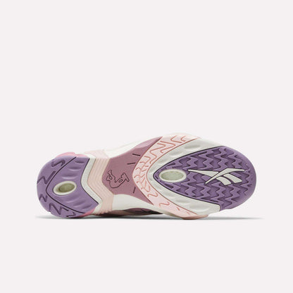 The image shows the sole of the Reebok Shaqnosis Low Shoes, featuring purple, pink, and off-white colors with textured patterns, Hexalite cushioning details, and a visible Reebok logo on the right side.