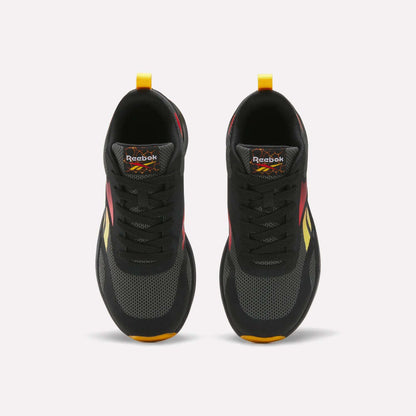 Top view of a pair of Reebok Energen Running Shoes for little kids in black with red, yellow, and orange accents, black laces, and yellow heel pull tabs. These shoes feature a cushioned midsole for added comfort and are positioned side by side on a white background.