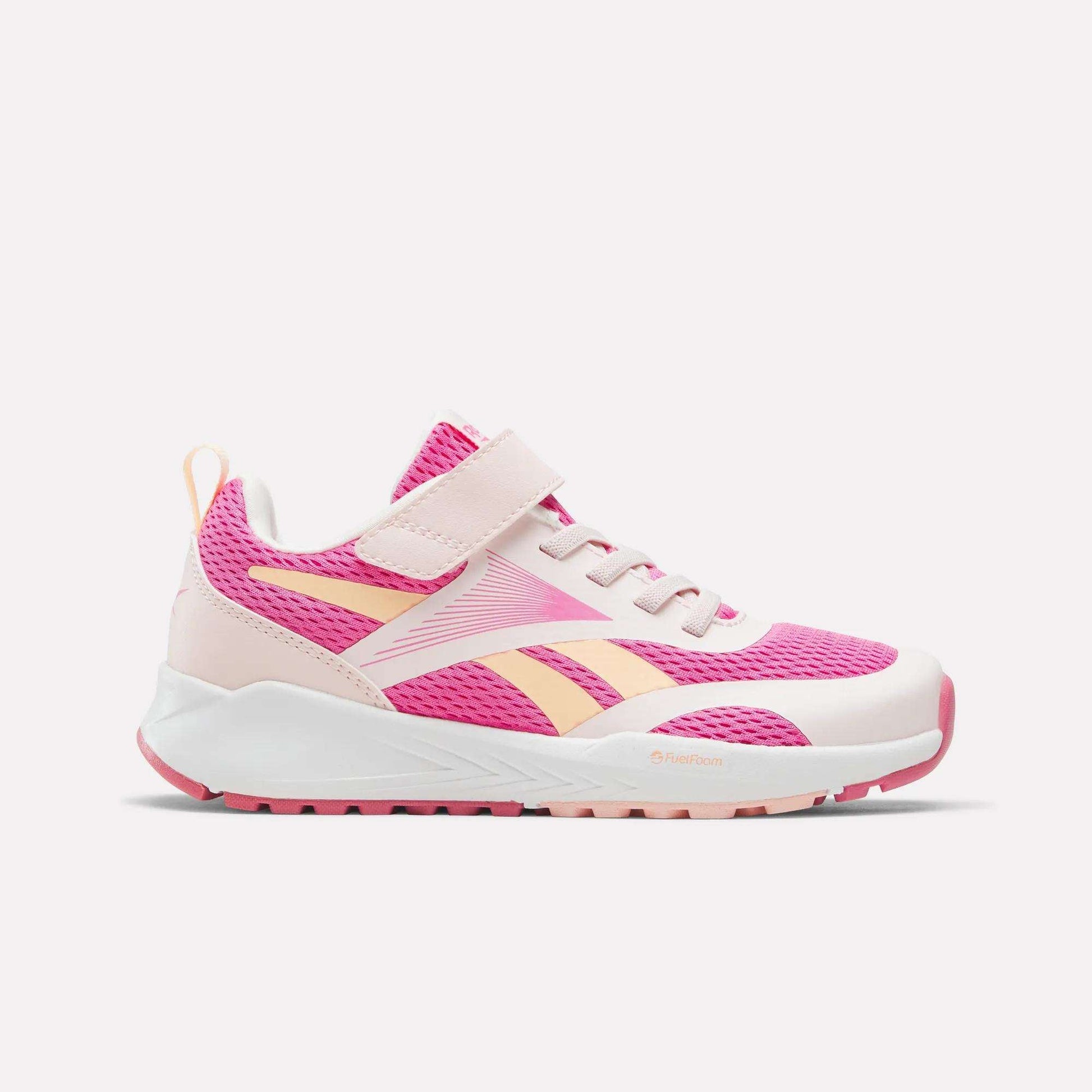 The Reebok Energen Running Shoes for little kids come in a vibrant True Pink, Pure Pink, and Future Peach colorway. They feature a white sole, Velcro strap, and breathable mesh uppers. The side displays the signature Reebok logo, while a convenient heel loop makes them easy to pull on—perfect for keeping kids comfortable during active days.