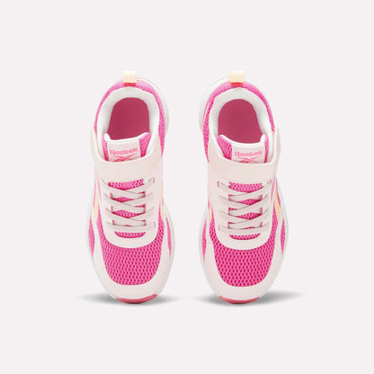 A pair of Reebok Energen Running Shoes for little kids in pink and white, viewed from above, showcasing breathable mesh uppers, laces, and a Velcro strap on each shoe, set against a light background.