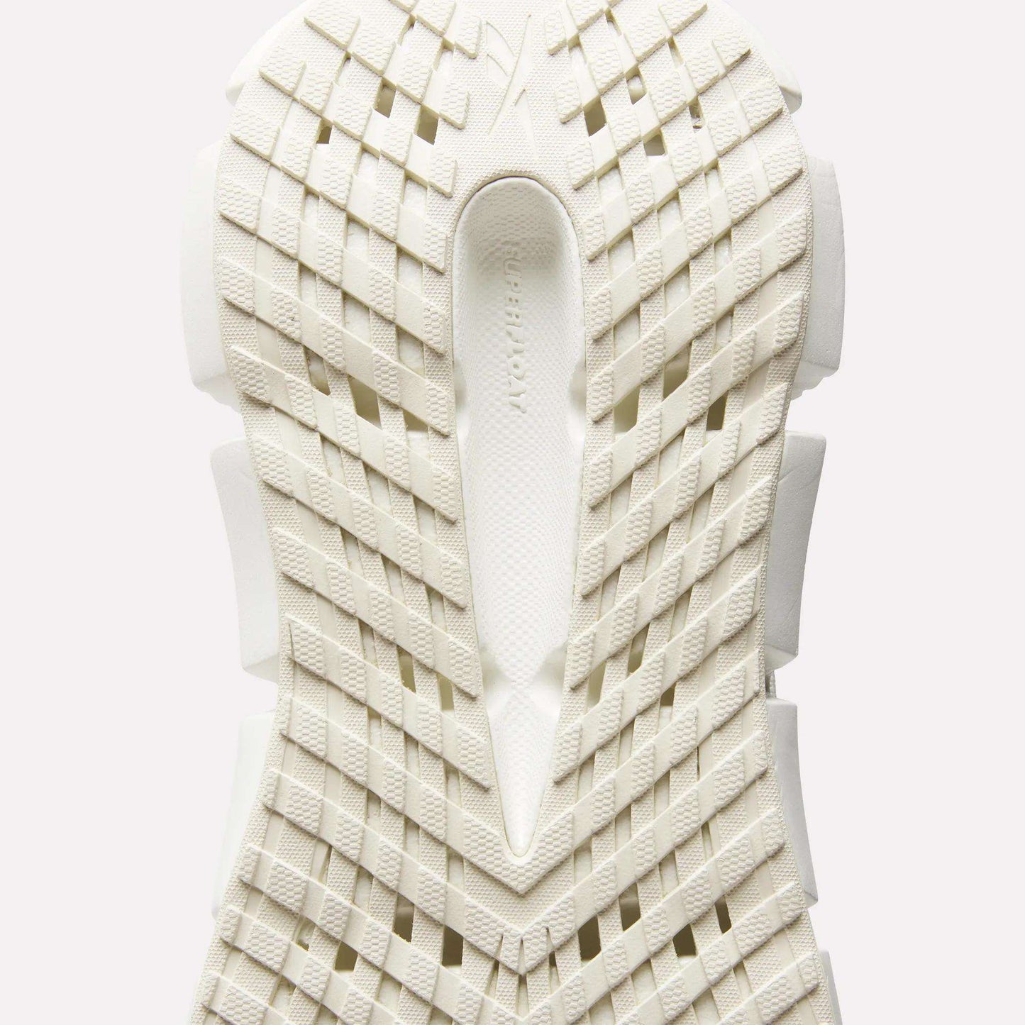 Close-up of the sole of Reebok Women's FloatZig 2 Running Shoes, featuring a white geometric grid tread and textured surface viewed from below, with subtle branding in the center to highlight its energy-returning cushioning.