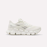 Side view of a white Reebok Women's FloatZig 2 Running Shoe featuring a mesh upper, unique angular outsole, and energy-return cushioning for comfort.