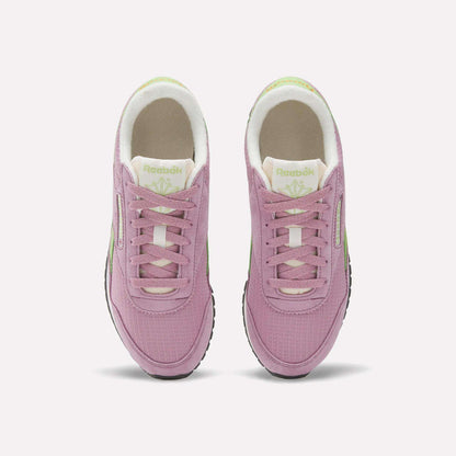 The Reebok Women's Classic AZ Shoes in pink with white soles and light green accents are shown from above on a white background, blending retro running style with a modern twist.