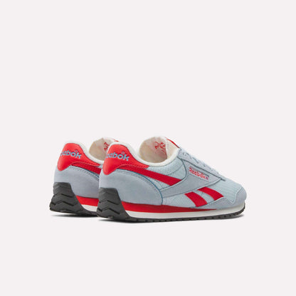 A pair of Women's Classic AZ Shoes by Reebok in light blue with red accents and black soles, set at an angle on a white background, highlight a retro running style.