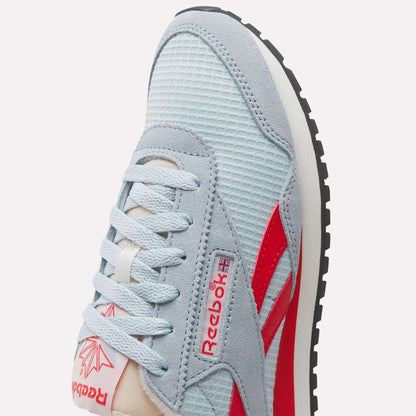 Close-up of a Women's Classic AZ Shoe by Reebok featuring a light blue mesh upper, suede accents, retro-inspired red logo and stripes, white laces, and a black rubber sole.