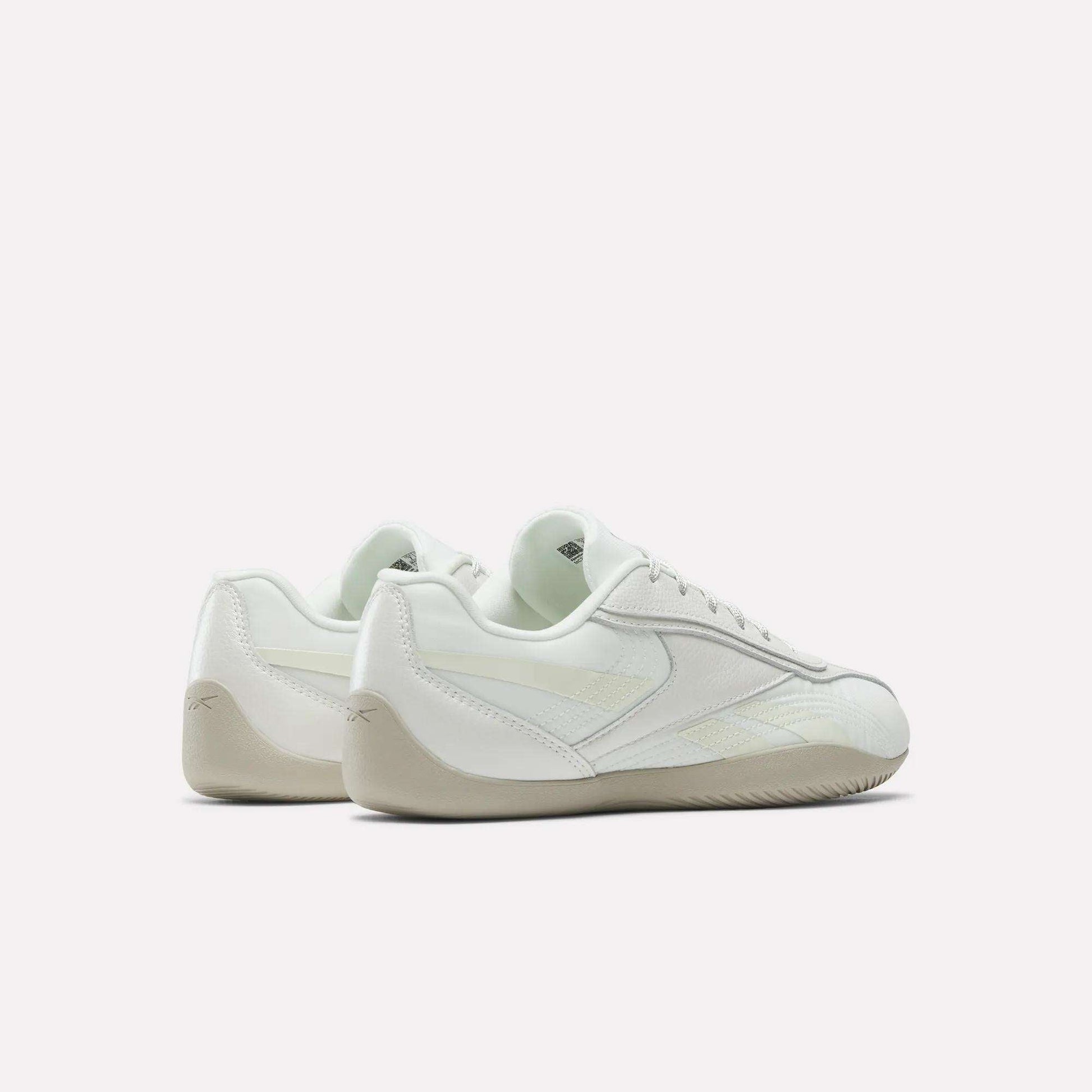 A pair of Reebok Women's Ultra Lo Shoes in white with beige soles, shown from back and side views against a plain white background, highlighting their low-profile design.