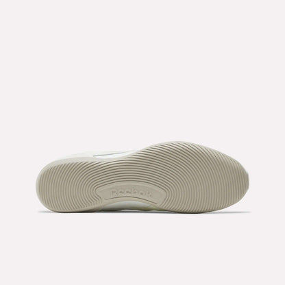 The image shows the bottom view of the Reebok Women's Ultra Lo Shoes in white, featuring a textured rubber sole with curved, wavy grip patterns and the Reebok logo embossed near the center, reflecting their streamlined, low-profile design.